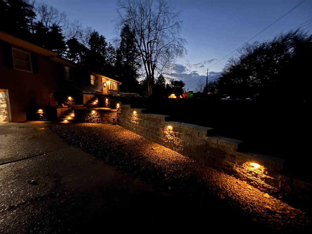 Rivera Brothers hardscape project featuring block retaining walls, steps and outdoor lighting
